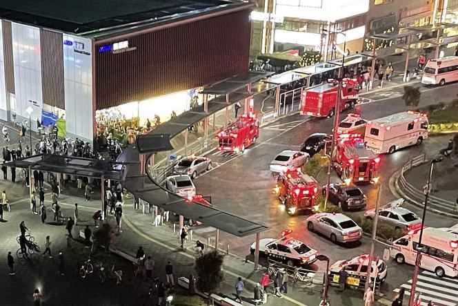 An aerial image shows rescuers outside Kokuryo station where the attacked train was parked in Tokyo on October 31, 2021.