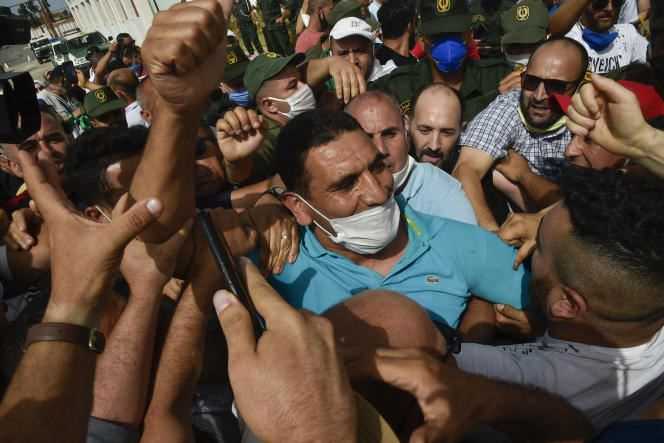 Karim Tabbou (center), one of the Hirak figures, is greeted by the crowd on his release from prison on July 2, 2020, near the town of Tipasa, 70 kilometers west of Algiers.