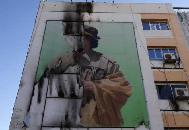 A torn poster of Muammar Gaddafi in Tripoli, in September 2011.
