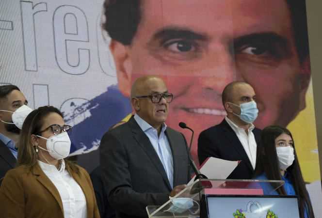 Press conference by the President of the National Assembly, Jorge Rodriguez (center) to discuss the arrest of businessman Alex Saab, whose portrait is displayed in the background, on October 16, in Caracas.