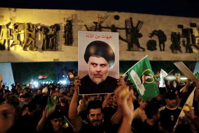 Supporters of Moqtada Al-Sadr celebrate, in Tahrir Square in Baghdad, on October 11, 2021, the victory of the Shiite leader's movement in the legislative elections.