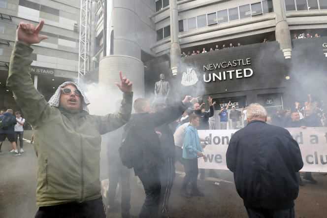 Newcastle United supporters celebrate the club's buyout announcement outside the stadium in Newcastle on October 7, 2021.