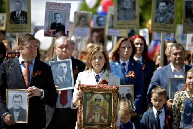 Natalia Poklonskaya, then Attorney General of Crimea, on May 9, 2016 in Simferopol, with a portrait of Tsar Nicholas II.
