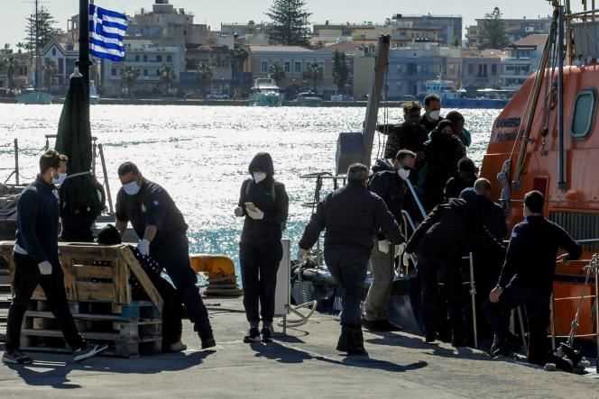 Migrants disembark from a Hellenic Coast Guard vessel after being rescued at sea on the island of Chios, Greece, October 26, 2021.
