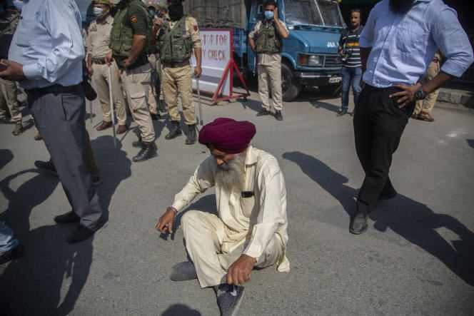 A member of the Sikh community blocks a road to protest the murder of a female teacher at a public school in Srinagar, India on Friday, October 8, 2021.