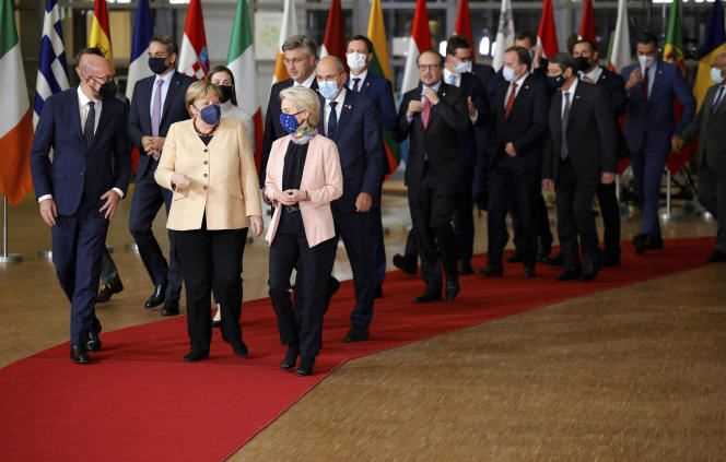 From left to right, European Council President Charles Michel, German Chancellor Angela Merkel and European Commission President Ursula von der Leyen before a group photo at a European summit in Brussels on 21 October 2021.