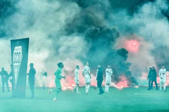 Ultras from the Saint-Etienne club lit rockets and smoke on the lawn of the Geoffroy-Guichard stadium, in Saint-Etienne.