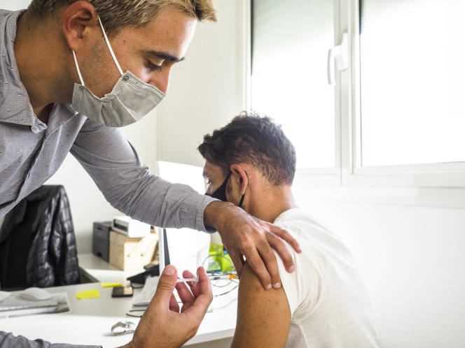 Doctor Pinto administers a dose of the Moderna vaccine to Moïse Wlado, a resident of Livry-Gargan, in Seine-Saint-Denis, on October 8, 2021.