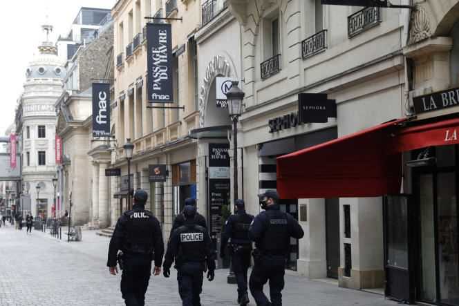 Police officers on patrol near the Le Printemps department store in Paris on January 31, 2021.