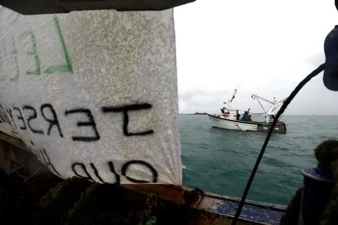 A banner hung from a French fishing boat during a protest outside the port of Saint Helier, off the British island of Jersey, in May 2021.