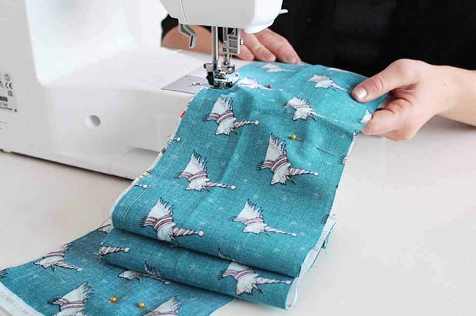 Sewing an advent calendar from a roll of fabric: fabric under a sewing machine