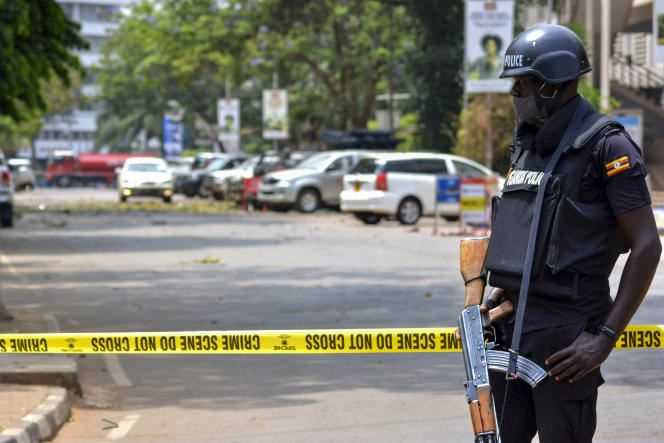 Members of the security forces secure the area around buildings where attacks took place, which left three people dead and thirty-three injured in Kampala on November 16, 2021.