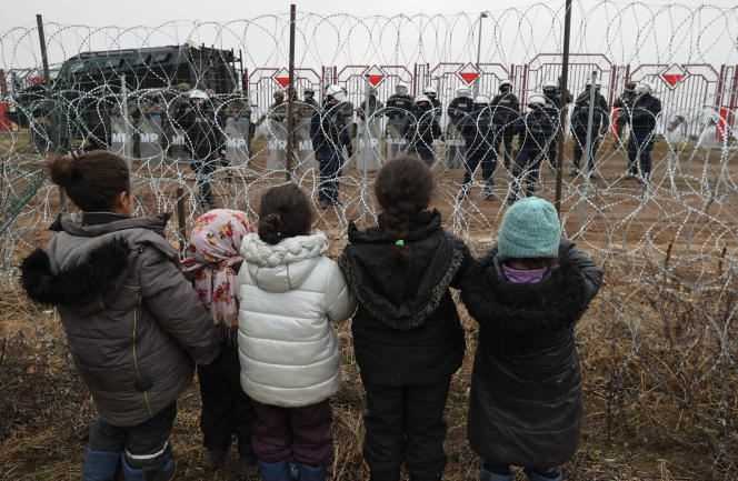 Migrant children face Polish border guards on November 17, 2021.
