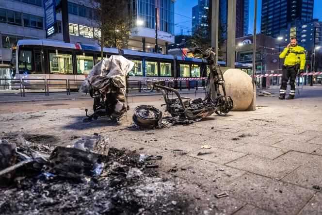 An electric scooter burnt down in Rotterdam after a protest against sanitary restrictions that escalated into riots on November 20, 2021.