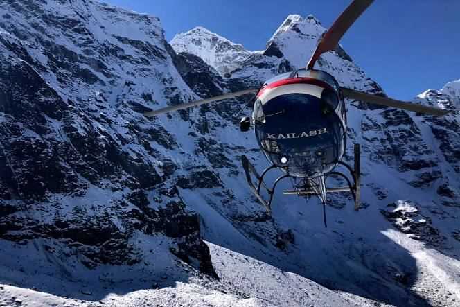 A helicopter flies over, on November 1, 2021, the site where three French climbers disappeared in the Himalayas, in Nepal.