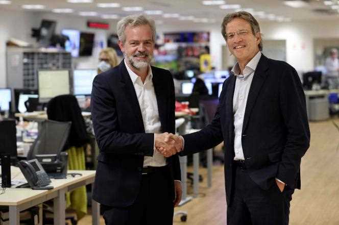 The CEO of Agence France-Presse, Fabrice Fries (right) and Sébastien Missoffe, the managing director of Google in France, at the premises of AFP, in Paris, on November 17, 2021.