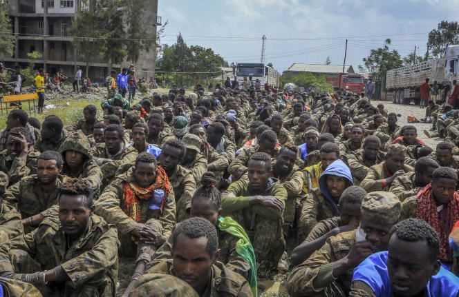 Captured Ethiopian government soldiers and allied militia members sit in a row waiting to be taken to a detention center in Makale, the capital of northern Ethiopia's Tigray region, on October 22, 2021.
