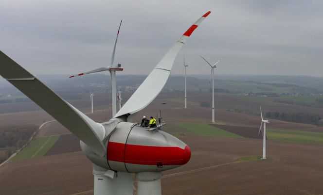 Two technicians maintain an Enercon E92 wind turbine in Bernsdorf, Germany on Monday, November 15, 2021.