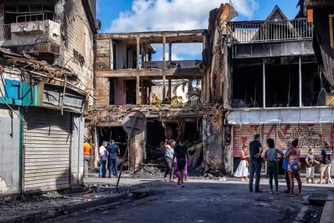 In front of the charred remains of a building in Pointe-à-Pitre (Guadeloupe), November 21, 2021.