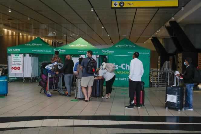 Travelers waiting to undergo a PCR test at OR Tambo International Airport in Johannesburg on November 27, 2021.