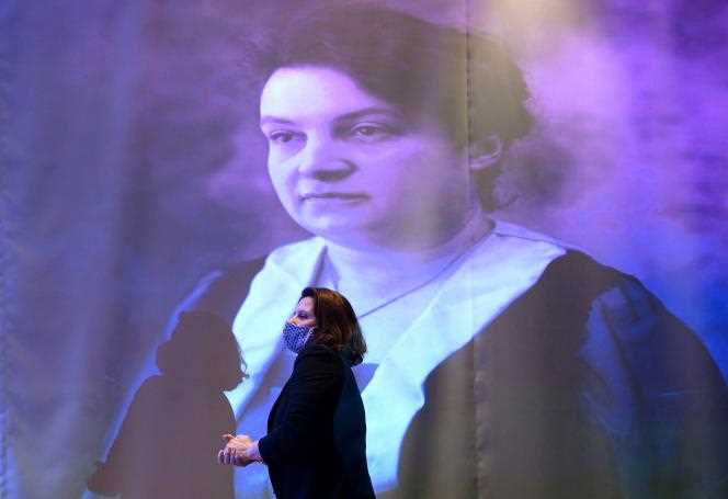 The Minister in charge of sports Roxana Maracineanu in front of a portrait of Alice Milliat, during the unveiling of a statue in tribute to the pioneer of women's sport, at the headquarters of the French National Olympic and Sports Committee, in Paris, March 8, 2021 .