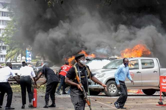 Cars on fire after a bomb exploded near Parliament in Kampala on November 16, 2021.