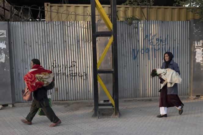 Civilians flee Sardar-Mohammad-Daoud-Khan hospital, where 25 people were killed in an attack, in Kabul on November 2, 2021.