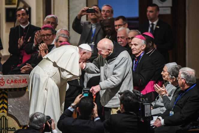 Pope Francis kisses the hand of Father Jean-Pierre Schumacher in Saint-Pierre Cathedral in Rabat, Morocco, March 31, 2019.