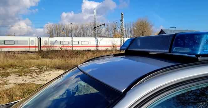 A police car is parked in the Seubersdorf station (Bavaria, Germany) on November 6, 2021, near the high-speed train (ICE) in which a 27-year-old man stabbed four people.