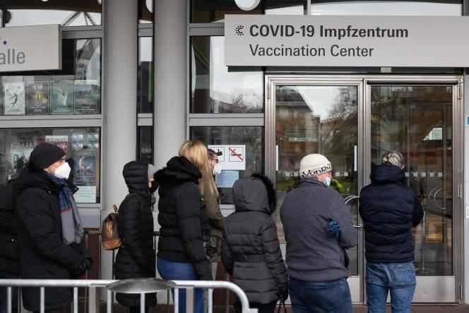 Germans wait in front of a vaccination center in Frankfurt am Main on November 30, 2021.