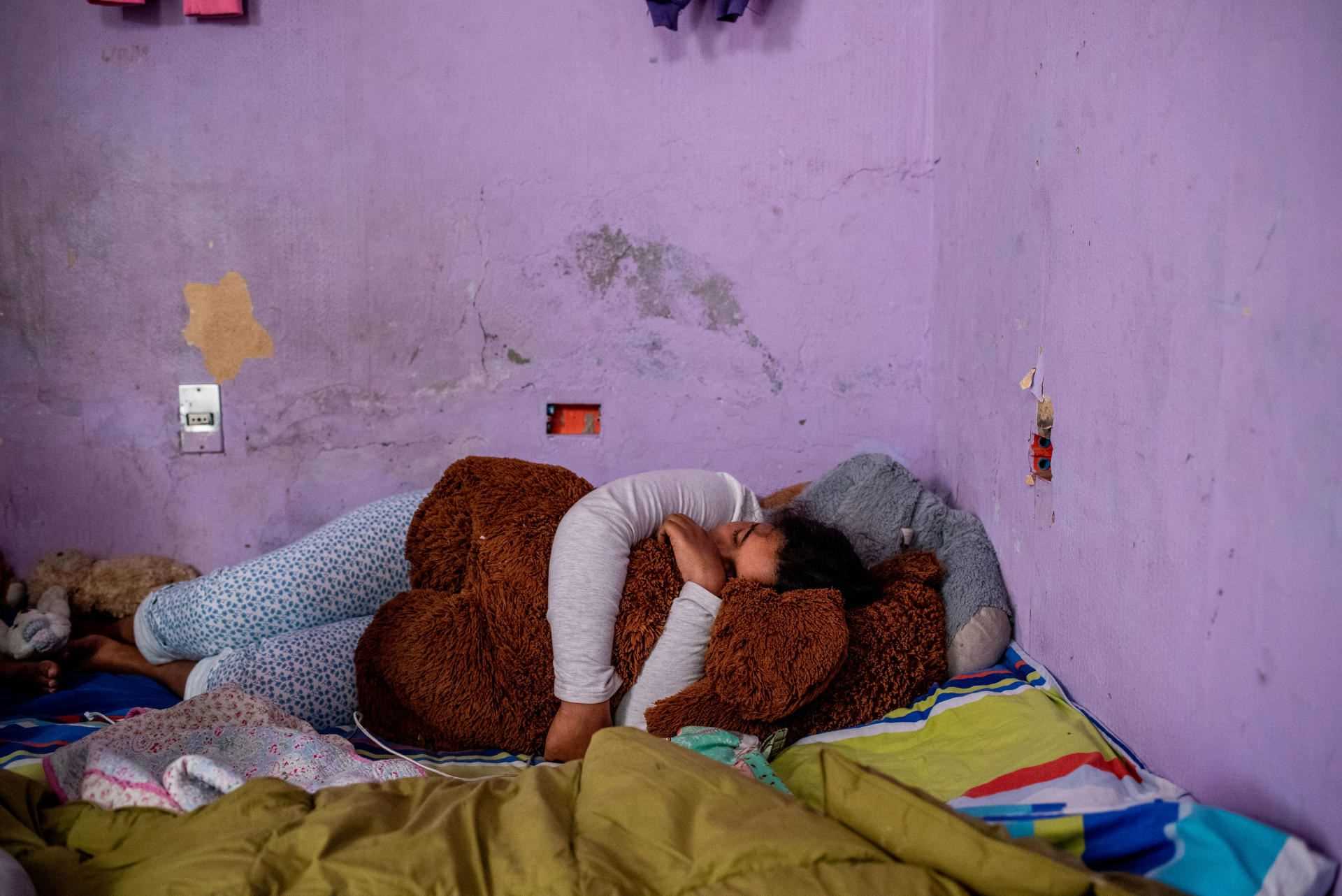 Rosneidi, 11, in the temporary room where she sleeps with her family, in Santiago, on November 19, 2021
