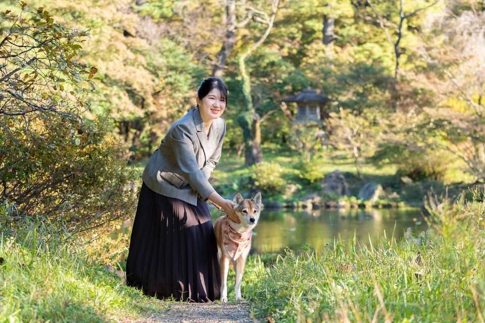 Princess Aiko is walking with her dog Yuri through the garden of the Imperial Residence in the Imperial Palace in Tokyo on November 14, 2021.  The photo was taken from the "Imperial Household Agency of Japan" made available.