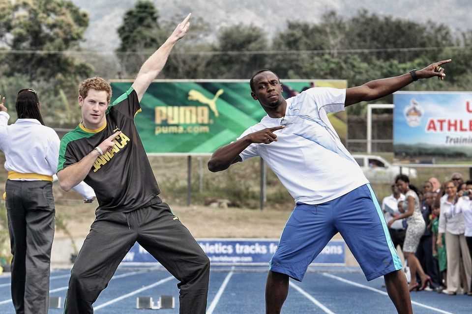 Prince Harry and Usain Bolt in the typical winning pose of the sprinter after a race in Jamaica 