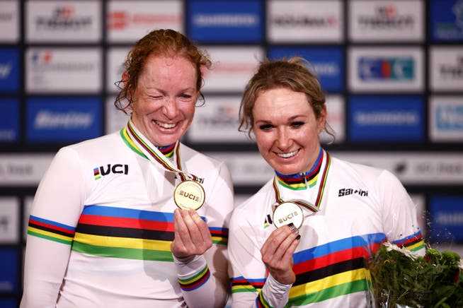 The Dutch Amy Pieters (right) and Kirsten Wild celebrate their gold medals on the podium after winning the women's Madison final in France in October 2021.