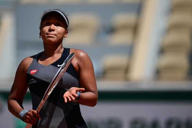Japan's Naomi Osaka celebrates her victory over Romania's Patricia Maria Tig in their women's singles first round match at the Roland-Garros tournament in Paris on May 30, 2021.