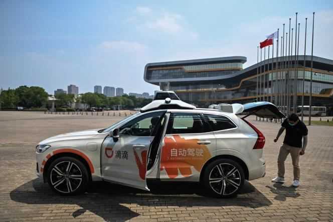 A driver (left) in an autonomous taxi from Didi Chuxing preparing for a pilot test on the streets of Shanghai, July 22, 2020.