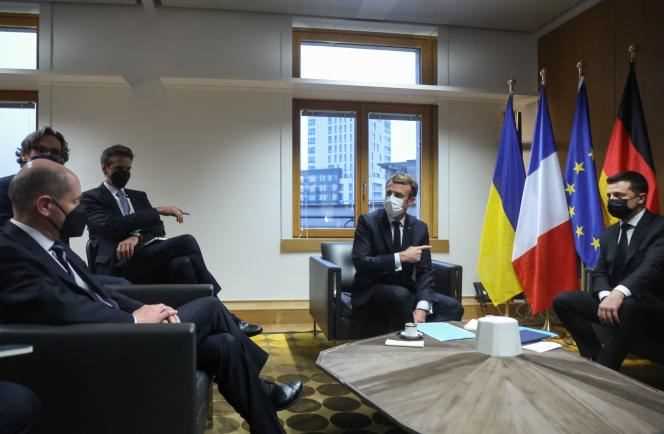 German Chancellor Olaf Scholz (left) and French President Emmanuel Macron (center) hold talks with Ukrainian President Volodymyr Zelensky (right) as part of the Eastern Partnership summit at the European Council, in Brussels, December 15, 2021.