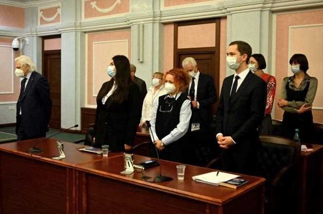 Lawyers for the NGO Memorial listen to the Russian Supreme Court's announcement of its dissolution in Moscow on December 28, 2021.