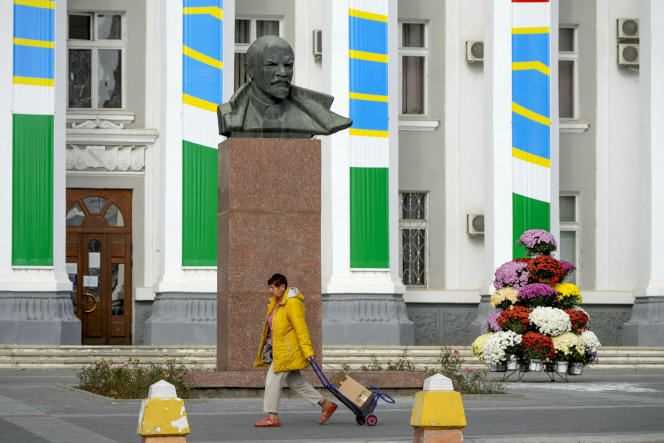 A woman walks past a statue of Lenin, in Tiraspol, in the break-away region of Moldova, Transnistria, on October 31, 2021.