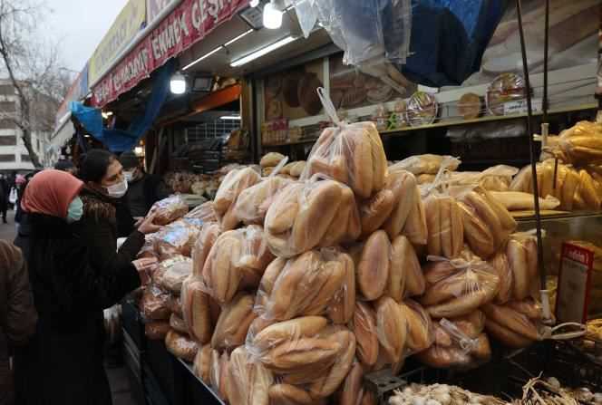 Women buy bread at a market in Ankara, December 20, 2021.