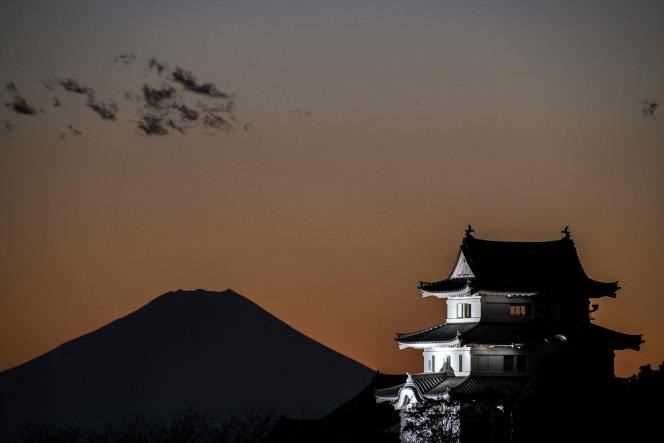 Sekiyado Castle illuminated at night, along with Mount Fuji, from Sakai, Japan on November 24, 2021.