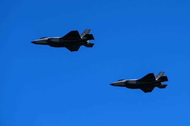 Two US Air Force Lockheed Martin F-35 fighter jets fly over Houlgate beach in northwestern France on June 6, 2021.
