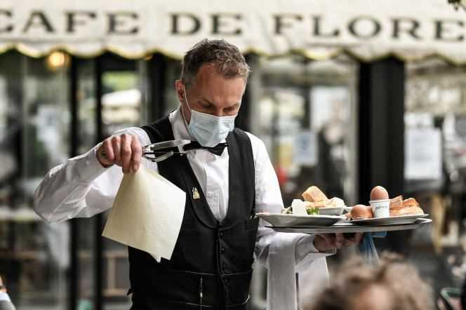 A waiter at the terrace of the Café de Flore, in Paris, on May 19, 2021.