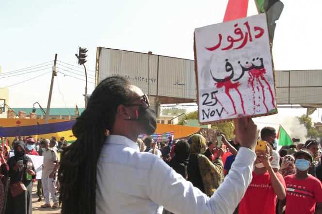 A protester holds up a sign reading 
