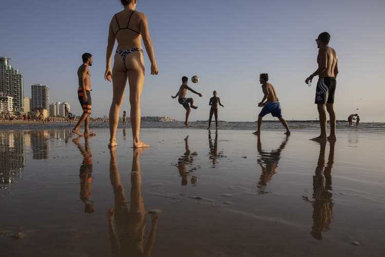 Young Israelis play foot volleyball on Tel Aviv Beach. 