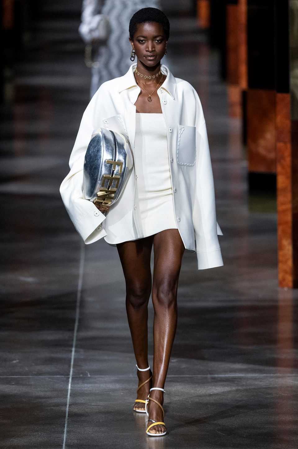 The model presents the style in extra length on the catwalk for the Fendi spring / summer collection 2022. 
