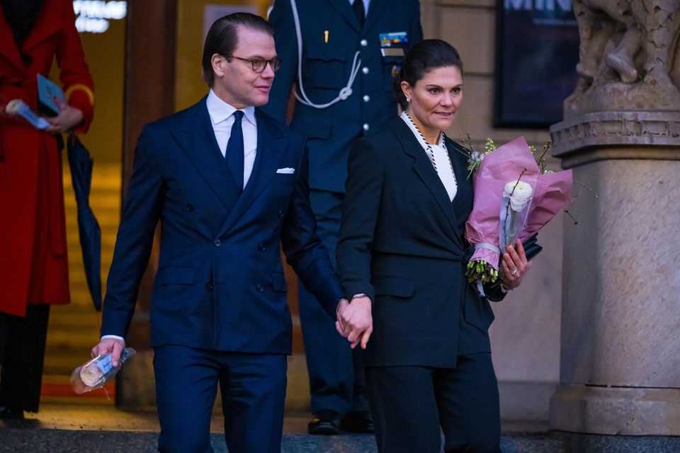 Princess Victoria holds hands with Prince Daniel after their speech at the Micael Bindefeld Foundation's Holocaust Remembrance Day celebration, January 27, 2022, in Stockholm.