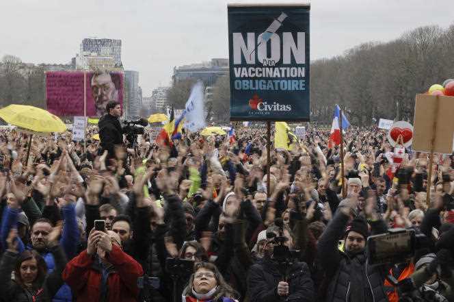 Demonstrators cheer during a march against measures aimed at stemming the Covid-19 epidemic, in Brussels, on January 23, 2022.