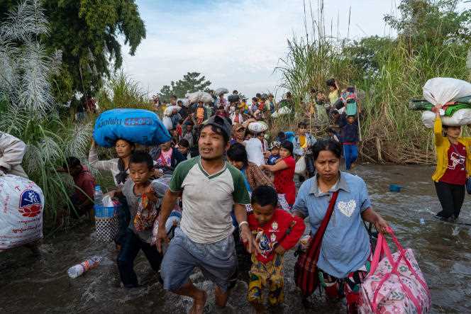 Villagers flee artillery shells fired by the Burmese army near Lay Kay Kaw in Myawaddy township in eastern Karen state on December 19, 2021.