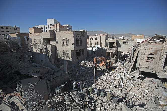 Residents of Sanaa inspect the rubble of buildings damaged by airstrikes by the Saudi-led coalition, Tuesday, January 18, 2022.